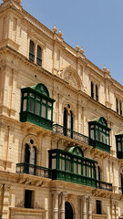 Typical narrow streets with colorful balconies in Malta. Traditional colorful balconies in old town of Valletta, Malta. Architecture background. Facade of the building in the old town, Malta island