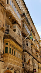 Typical narrow streets with colorful balconies in Malta. Traditional colorful balconies in old town of Valletta, Malta. Architecture background. Facade of the building in the old town, Malta island