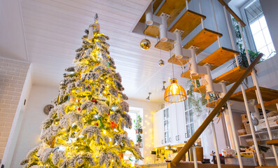 Christmas decor in white kitchen, modern village interior with a snowy Christmas tree and fairy...