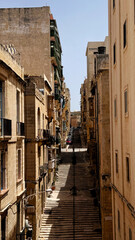 Typical narrow streets with colorful balconies in Malta. Traditional colorful balconies in old town of Valletta, Malta. Architecture background. Facade of the building in the old town, Malta island