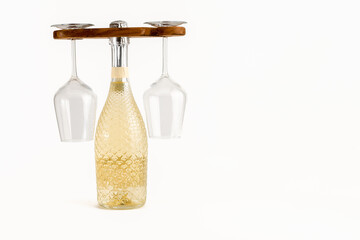 Wine bottle and pair of glasses caddy holder yoke style isolated on a white background
