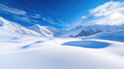 A bright winter day in the mountains, with sharp shadows on fresh snow and a vibrant blue sky providing a striking contrast.