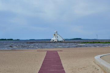 Lighthouse on the sandy beach of Nalikari in Oulu, Finland. The local landmark is also used as an observation tower for tourists. Early spring, cold, deserted.