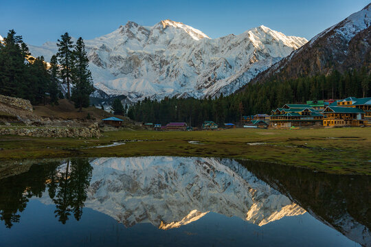 Stunning reflection of Nanga Parbat, the world's ninth-highest mountain, captured in a pristine alpine lake at Fairy Meadows National Park, Gilgit-Baltistan, Pakistan.