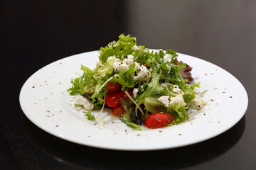 Salad with feta cheese. Salad with cheese, tomatoes and herbs.