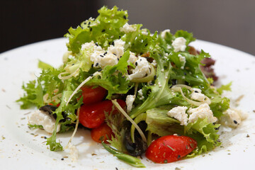 Salad with feta cheese. Salad with cheese, tomatoes and herbs.