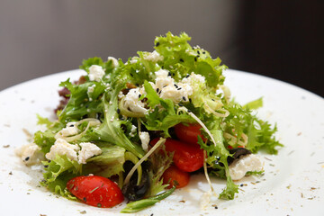 Salad with feta cheese. Salad with cheese, tomatoes and herbs.