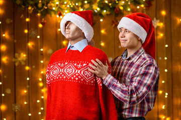 A teenage boy poses with a male mannequin as a friend in New Year decorations with festive illumination and garlands, Christmas lights and decorations, Holiday theme