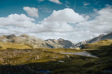 A beautiful mountain landscape featuring a small serene lake in the middle