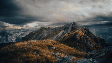 A majestic mountain set against a backdrop of a cloudy sky