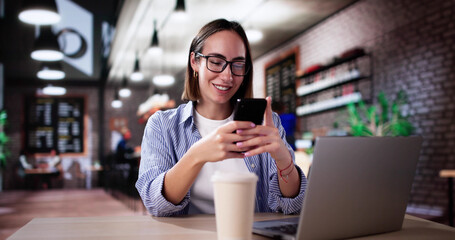 Student Using Phone And Laptop