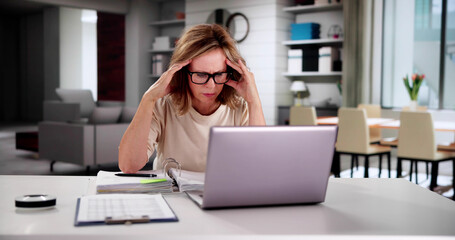 Worried Woman Calculating Bills At Home