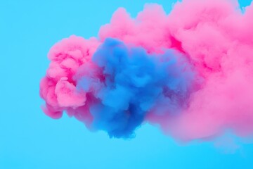 Fototapeta premium Vibrant pink and blue smoke swirling against a bright blue background, creating an artistic and dynamic visual effect.