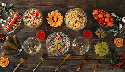 Christmas New Year dishes, traditional Olivier salad, vegetable salad of cucumbers, tomatoes and radishes and a variety of vegetable snacks, holiday serving concept,