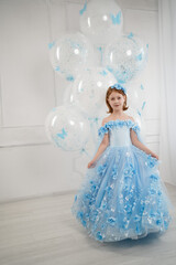 little girl in blue dress with giant helium balloons