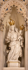 Fototapeta premium PAVIA, ITALY - SEPTEMBER 8, 2024: The marble statue of Madonna of Scapular in the church Chiesa di Santa Maria del Carmine by scultore Sassi from begin of 20. cent.