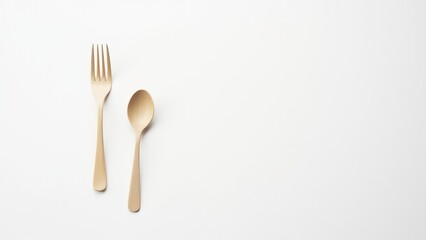 Minimalist white fork and spoon on a clean white background, highlighting simplicity and elegance. Everyday things used for dining.