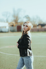 Beautiful girl in a denim jacket in the sunlight sunset.