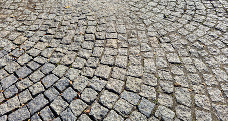 Textured cobblestone pavement in a circular pattern. Ideal for backgrounds in design projects or as...