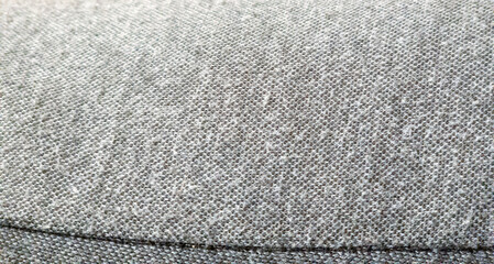 Close-up view of a textured grey fabric, showcasing its intricate weave and softness. Ideal for...