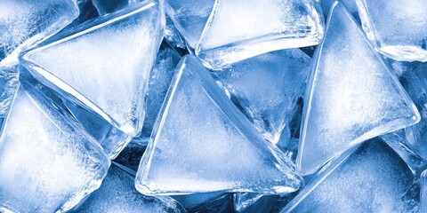 Obraz premium Glittering ice triangles lie together, reflecting light in a stunning display, evoking the chill of winter and the beauty of natural frozen formations in a cold environment