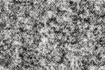 Fototapeta premium A black and white, close-up image of a rough, textured surface. The texture is primarily composed of many small, white flecks on a black background