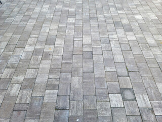 Textured paved surface featuring gray stones arranged in a geometric pattern, ideal for backgrounds...