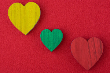 Traffic light green, yellow, red hearts on the red background.