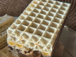 Delicious close-up of a crunchy wafer with layered filling, perfect for dessert or snack lovers.