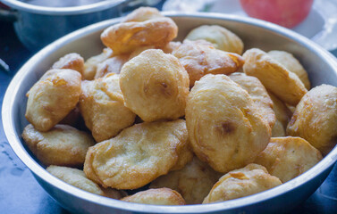 Bowl of freshly fried dough snacks, golden and crispy, perfect for breakfast or snack time.