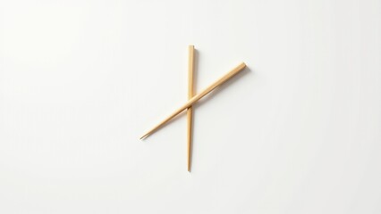 Pair of wooden chopsticks arranged on a white background, showcasing a minimalist style. Everyday things for dining.