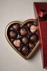 Obraz premium Heart shaped box of chocolates isolated on white background, cut out 