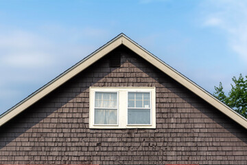 Rustic brown shingle house with white-trimmed windows in Brighton, Massachusetts, USA