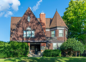 Historic Shingle Style Family Home with Conical Turret and Gabled Roof in Brighton, Massachusetts, USA 