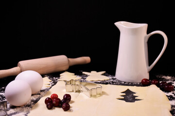 Christmas baking. Gingerbread dough in the shape of a Christmas tree, an angel, a star. Festive...