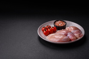 Fresh raw chicken thigh fillets with salt, spices and herbs