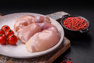 Fresh raw chicken thigh fillets with salt, spices and herbs