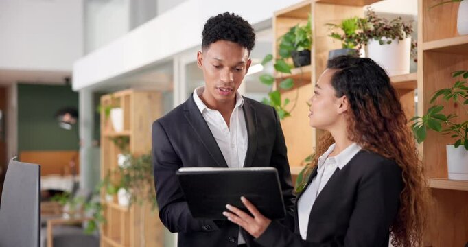 Hotel, reception and people with tablet at front desk for booking website, information or support. Man, woman and intern with tech in discussion for hospitality, training or help with online check in