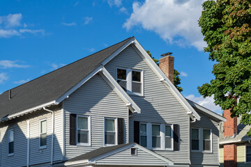 Beautiful Light Gray Clapboard Family Home with black shutters in Brighton, Massachusetts, USA