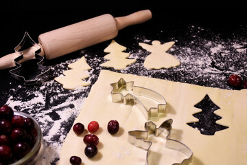 Christmas baking. Gingerbread dough in the shape of a Christmas tree, an angel, a star. Festive...