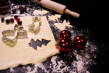 Christmas baking. Gingerbread dough in the shape of a Christmas tree, an angel, a star. Festive...