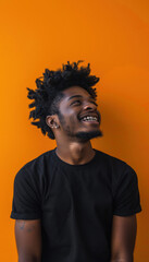Fototapeta premium Energetic Young Man Smiling Against Bold Orange Background for Positive Branding Design