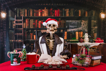 Christmas skeleton reading book in old library with candy canes and gingerbread cookies