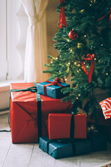 gifts under the tree, lots of gift boxes. Festive mood
