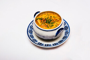 hot cassava broth, traditional homemade soup from Minas Gerais, Brazil, served hot with parsley and other vegetables