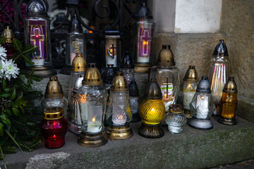 Tombstones decorated with colorful seasonal chrysanthemum flowers in cemetery during religious christian traditional autumnal event at a cemetery in Poland during All Saints Day, Zaduszki day, and Day