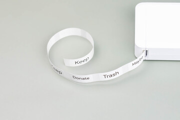 Label printer producing decluttering labels for organizing home spaces. Labels read Keep, Donate,...