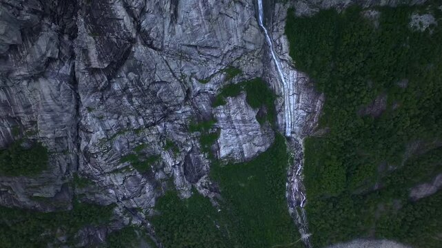 Waterfall ob the Slope of Ringedalsvatnet Lake where Troll Tongue or Trolltunga located. Aerial Drone Shot over a Fjord