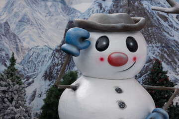 smiling snowman in the snow with christmas trees