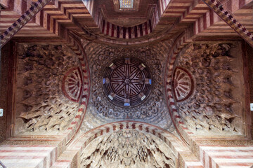 The vestibule chamber's dome with muqarnas and ablaq stonework of the historic Sultan Hassan Mosque and Madrassa in Islamic Cairo, Egypt. Hasan/